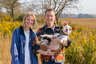 James and Kirstie Brittain-McVey holding their dog Moochie