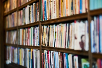 Close up of wooden bookshelves filled with books