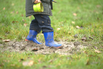 Young child walking through mud